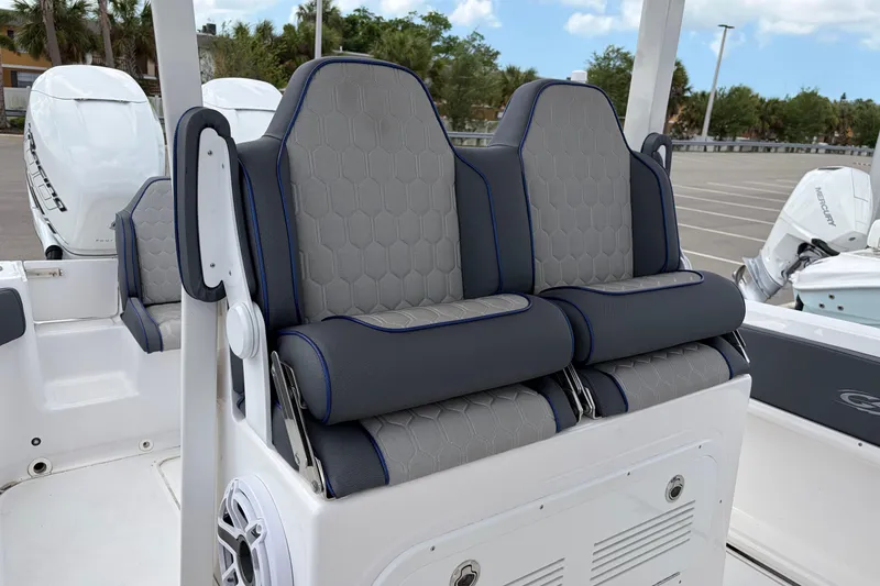Slide: The Image of 2025 Glasstream 328 SCX boat seats with hexagonal pattern and blue accents. - 27