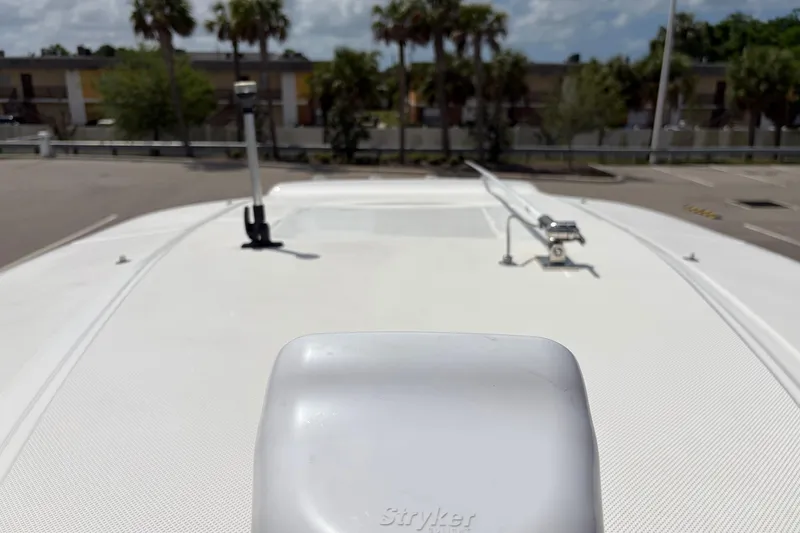 Slide: The Image of Rooftop view of 2025 Glasstream 328 SCX boat with clear sky and palm trees. - 28