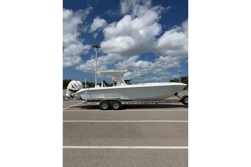 Slide: The Image of 2025 Glasstream 328 SCX boat on trailer under blue sky with clouds. - 3