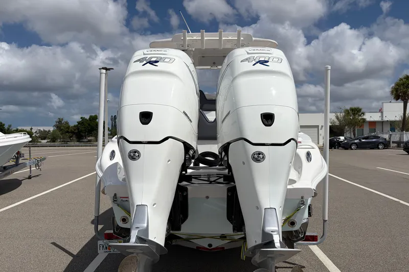 Slide: The Image of 2025 Glasstream 328 SCX boat with dual 400R outboard engines in a parking lot. - 30