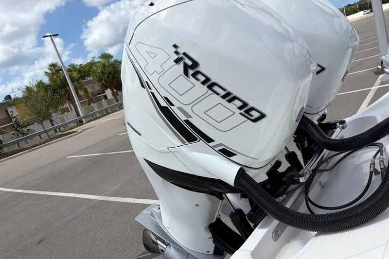 Slide: The Image of 2025 Glasstream 328 SCX with powerful iRacing 400 outboard engines in a parking lot. - 31