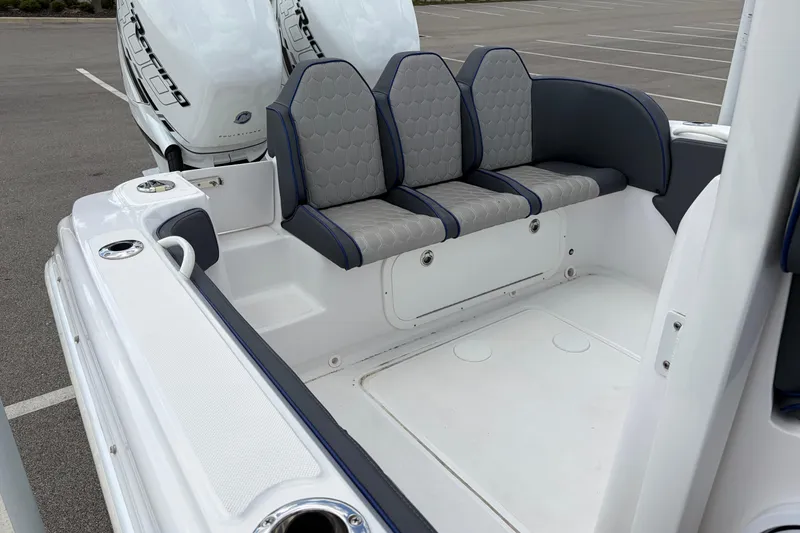 Slide: The Image of 2025 Glasstream 328 SCX boat interior with gray seating and twin outboard engines. - 32