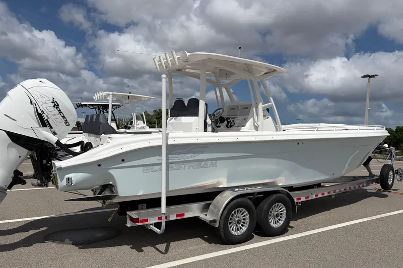 Slide: The Image of 2025 Glasstream 328 SCX boat on trailer, featuring powerful outboard engine, under a cloudy sky. - 36