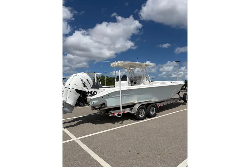 Slide: The Image of 2025 Glasstream 328 SCX boat on trailer under blue sky with clouds. - 4