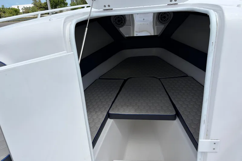 Slide: The Image of Interior cabin of 2025 Glasstream 328 SCX boat, featuring cushioned seating and modern design. - 40