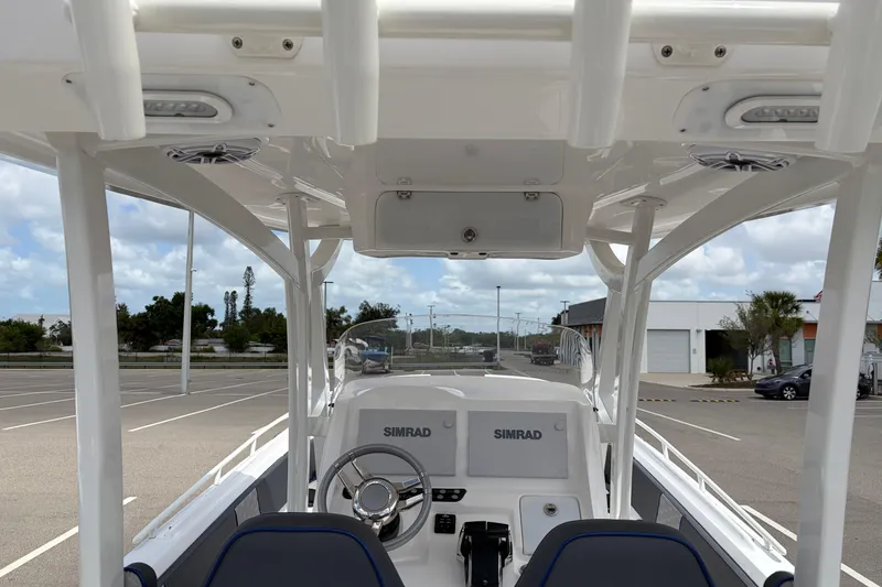 Slide: The Image of 2025 Glasstream 328 SCX boat interior with steering wheel and Simrad navigation system. - 41