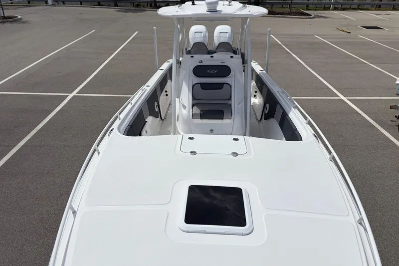 Slide: The Image of 2025 Glasstream 328 SCX boat in a parking lot, showcasing sleek design and spacious deck. - 43