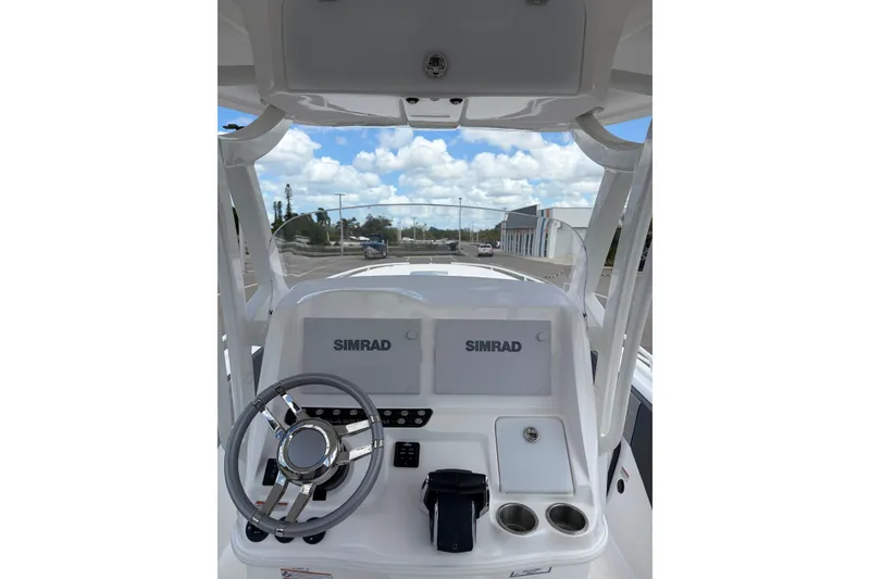 Slide: The Image of 2025 Glasstream 328 SCX boat dashboard with Simrad displays and steering wheel. - 5