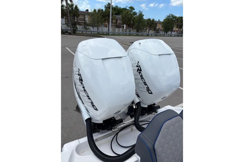 Slide: The Image of Twin outboard engines on a 2025 Glasstream 328 SCX boat in a parking lot. - 6