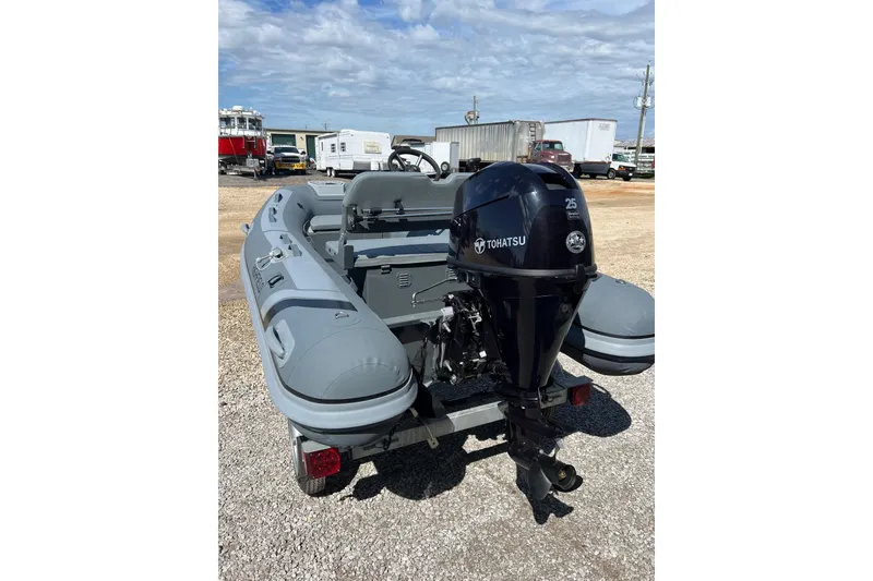 Slide: The Image of 2026 Highfield Classic 340 FCT boat with Tohatsu outboard motor on a trailer. - 10