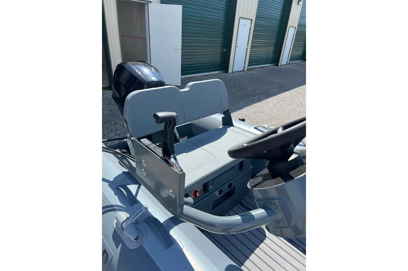 Slide: The Image of 2026 Highfield Classic 340 FCT boat interior with steering console and seating. - 11