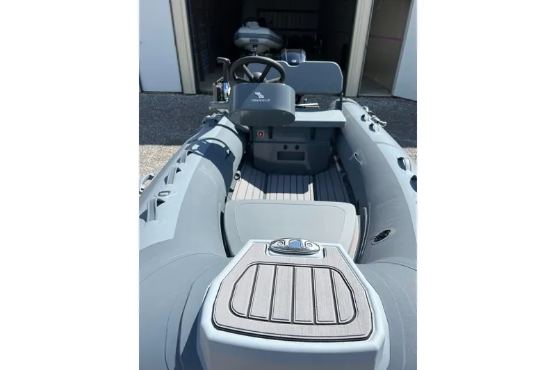 Slide: The Image of 2026 Highfield Classic 340 FCT boat interior with steering console and seating. - 13