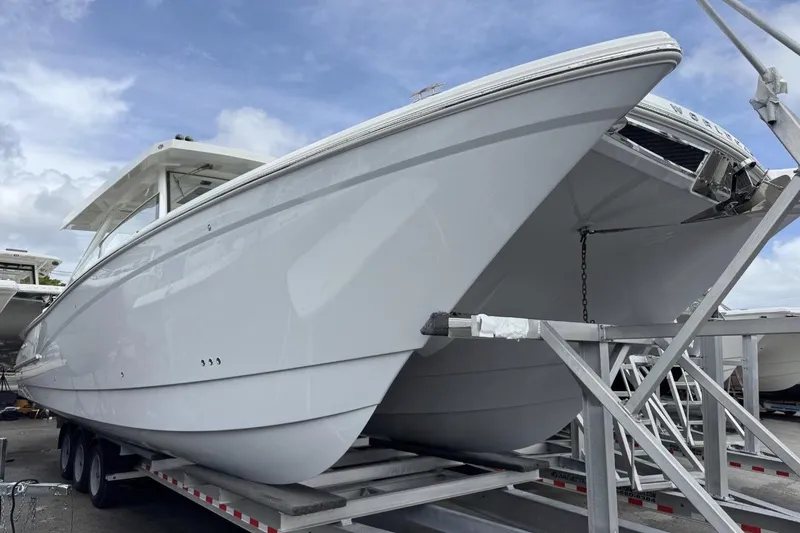 The Image of 2026 World Cat 400 DC-X Island boat on trailer under cloudy sky. - 0