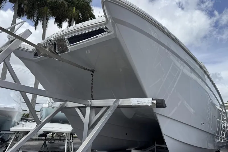 Slide: The Image of 2026 World Cat 400 DC-X Island boat on a trailer, under a cloudy sky. - 2