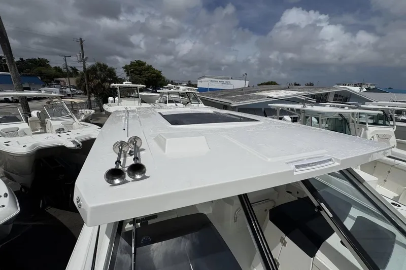 Slide: The Image of 2026 World Cat 400 DC-X Island boat with sleek design and dual horns on deck. - 22