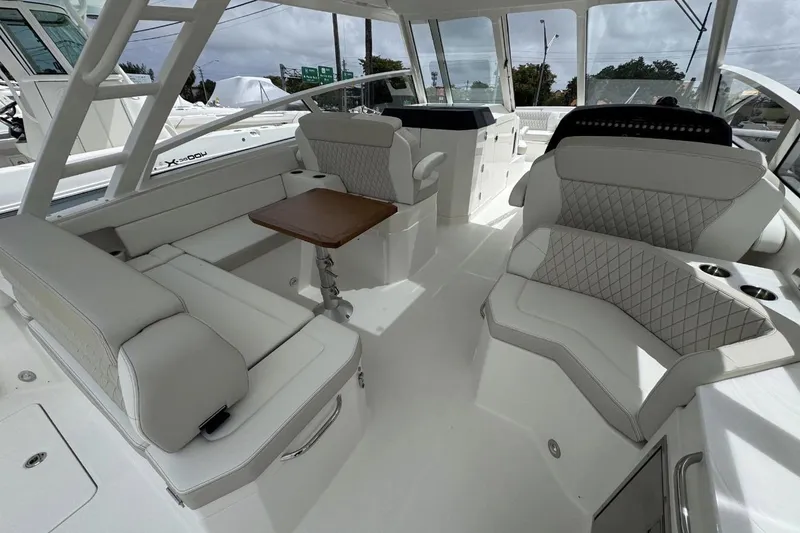 Slide: The Image of Luxurious interior of 2026 World Cat 400 DC-X Island boat with plush seating and table. - 24