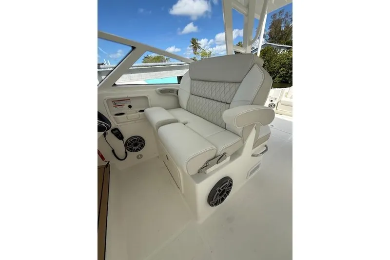 Slide: The Image of Luxury seating on 2026 World Cat 400 DC-X Island boat, featuring plush white upholstery. - 3