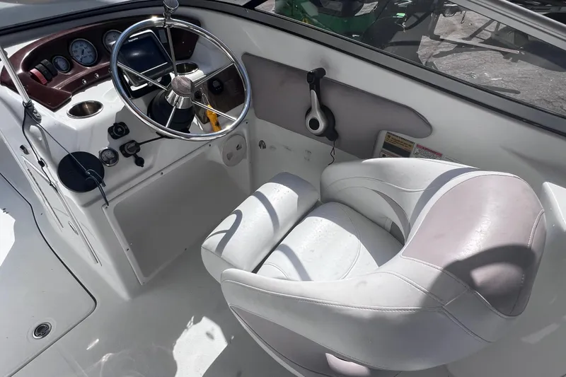 Slide: The Image of 2012 SouthWind 212 SD boat cockpit with steering wheel and captain's chair. - 13