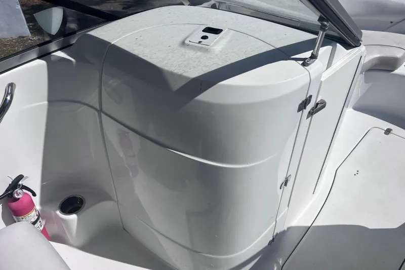 Slide: The Image of 2012 SouthWind 212 SD boat interior with white seating and a fire extinguisher. - 18