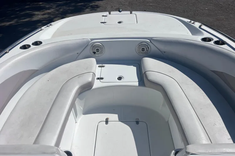 Slide: The Image of 2012 SouthWind 212 SD boat interior with white seating and cup holders. - 20