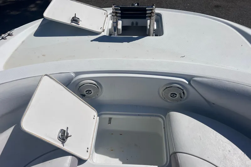 Slide: The Image of 2012 SouthWind 212 SD boat interior with open storage compartments and speakers. - 23