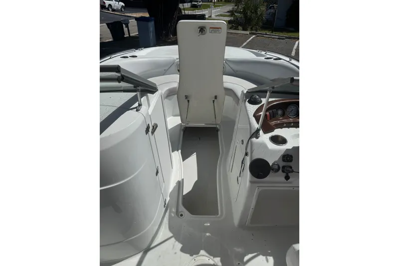 Slide: The Image of Interior view of a 2012 SouthWind 212 SD boat, featuring a storage compartment and control panel. - 24
