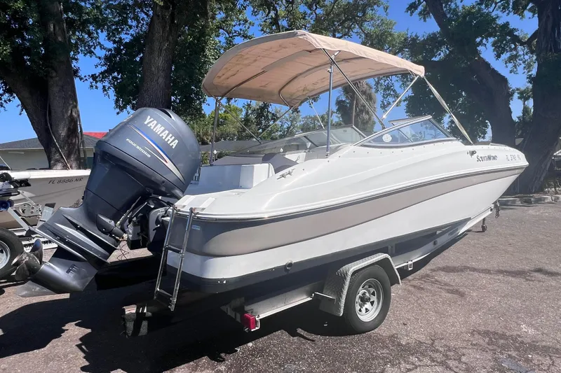 Slide: The Image of 2012 SouthWind 212 SD boat with Yamaha outboard motor on trailer, parked outdoors. - 7