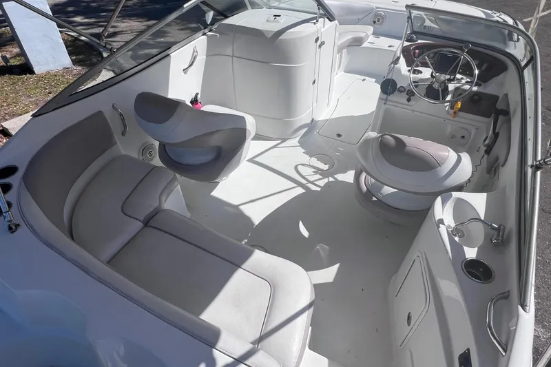 Slide: The Image of 2012 SouthWind 212 SD boat interior with seating, steering wheel, and cup holders. - 9