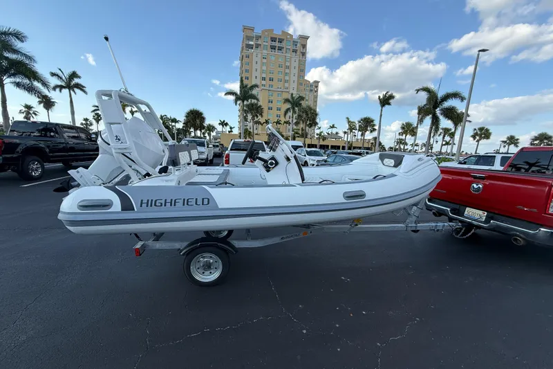 The Image of 2026 Highfield Sport 420 boat on trailer in parking lot with palm trees. - 1