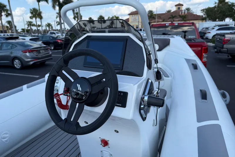 Slide: The Image of 2026 Highfield Sport 420 boat dashboard with steering wheel and control panel. - 4