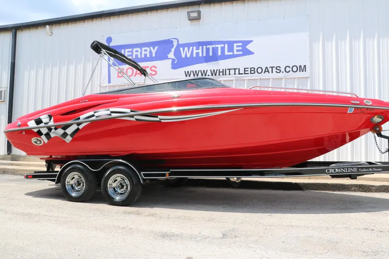 The Image of Red 2009 Crownline 23 SS boat on trailer, parked outside dealership. - 1