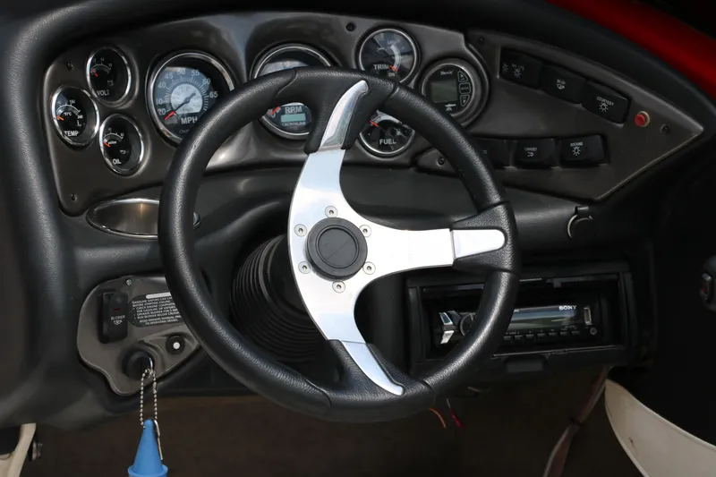 Slide: The Image of Dashboard of a 2009 Crownline 23 SS boat with steering wheel and gauges. - 21