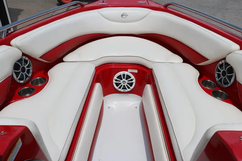Slide: The Image of 2009 Crownline 23 SS boat interior with red and white seating, cup holders, and speakers. - 23