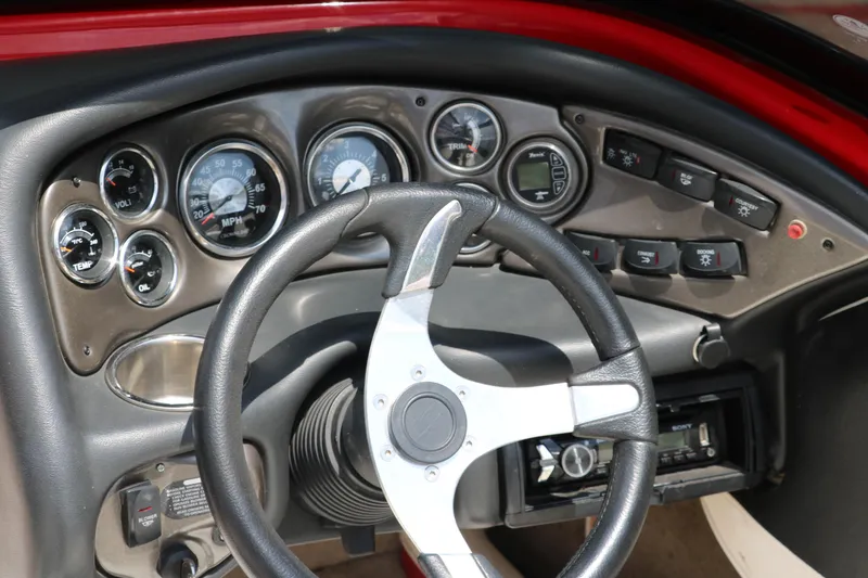 Slide: The Image of Dashboard of a 2009 Crownline 23 SS boat with steering wheel and gauges. - 32