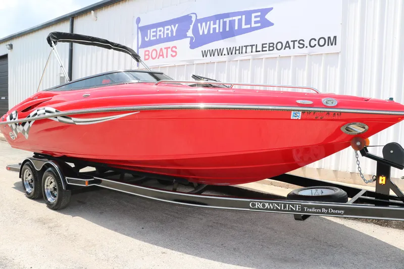 Slide: The Image of Red 2009 Crownline 23 SS boat on trailer, parked outside Jerry Whittle Boats dealership. - 4