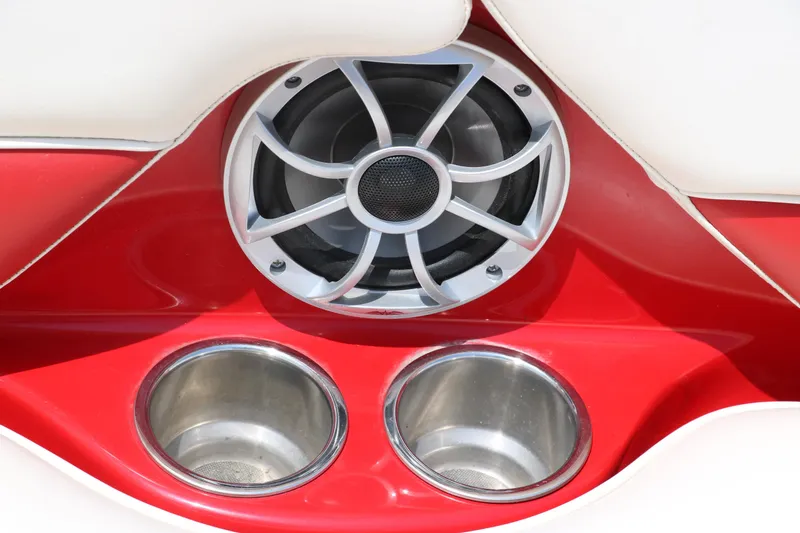 Slide: The Image of Speaker and cup holders on 2009 Crownline 23 SS boat, featuring red and white interior. - 41