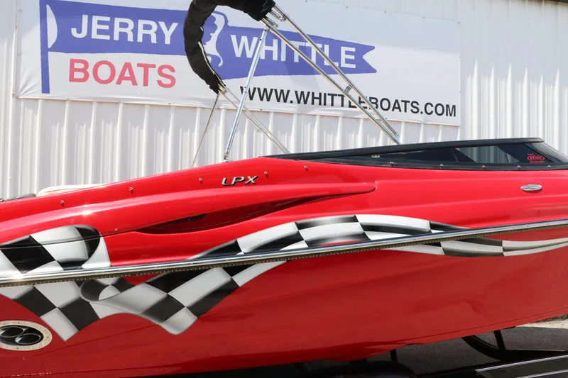 Slide: The Image of Red 2009 Crownline 23 SS boat with checkered flag design, displayed at Jerry Whittle Boats. - 47