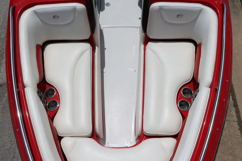 Slide: The Image of 2009 Crownline 23 SS boat interior with white and red seating, cup holders visible. - 51