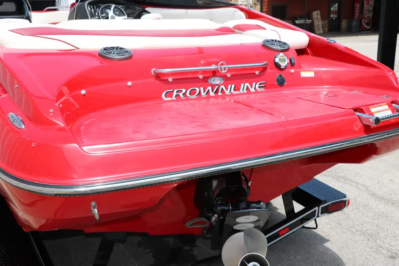 Slide: The Image of Red 2009 Crownline 23 SS boat rear view with visible propeller and branding. - 8