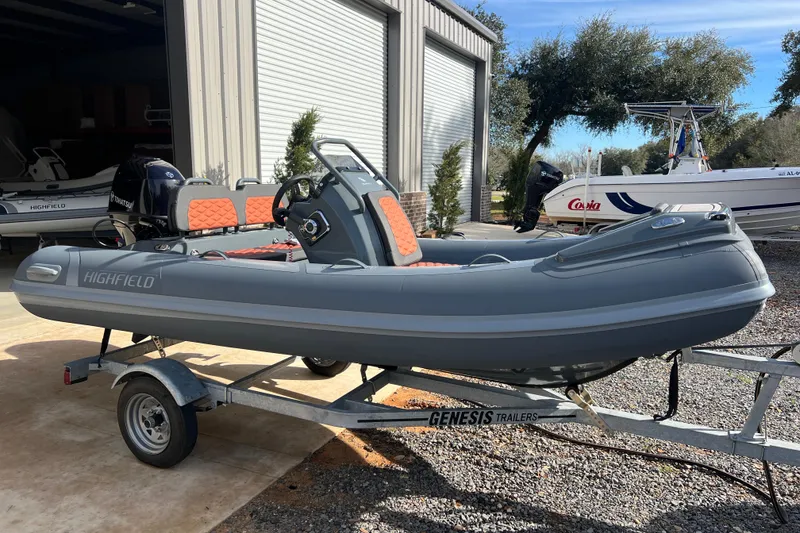 The Image of 2026 Highfield Sport 390 boat on trailer, parked outside a garage. - 1