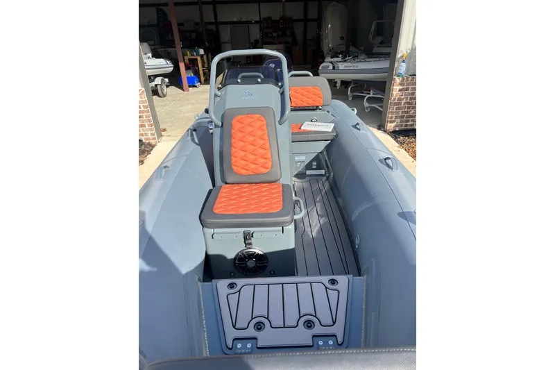 Slide: The Image of 2026 Highfield Sport 390 boat interior with orange quilted seats and sleek design. - 3
