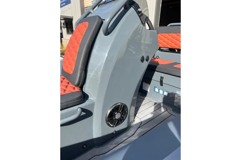 Slide: The Image of 2026 Highfield Sport 390 boat interior with orange quilted seats and sleek gray console. - 4