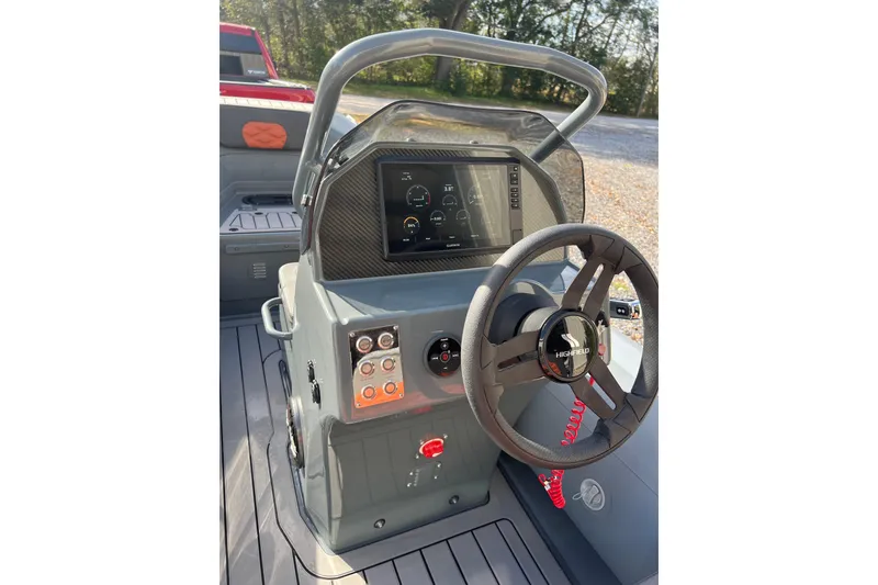 Slide: The Image of 2026 Highfield Sport 390 boat dashboard with steering wheel and digital display. - 5