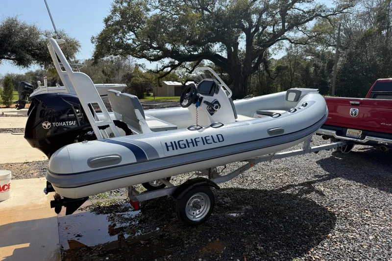 Slide: The Image of 2026 Highfield Classic 420 inflatable boat on trailer, featuring Tohatsu outboard motor. - 10