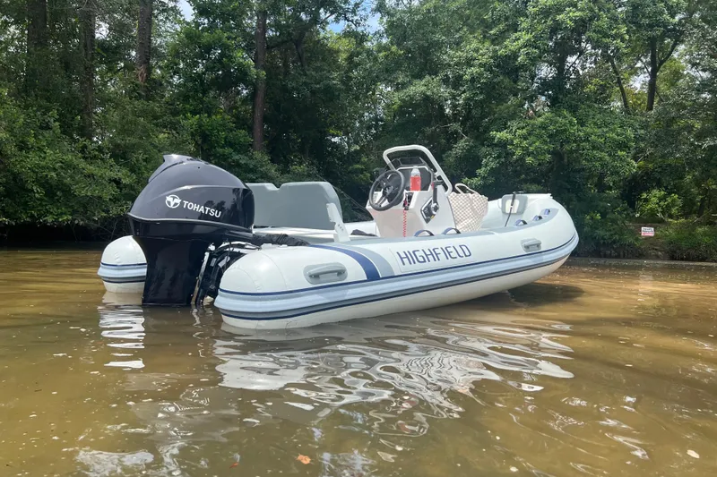 Slide: The Image of 2026 Highfield Classic 420 boat with Tohatsu engine on calm water. - 5