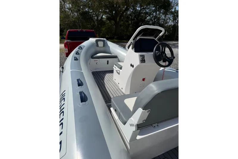 Slide: The Image of 2026 Highfield Classic 420 boat interior with steering console and seating. - 6