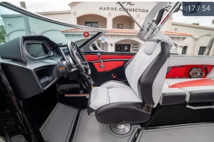 Slide: The Image of 2019 MasterCraft XStar boat interior with modern dashboard and seating at Marine Connection. - 13