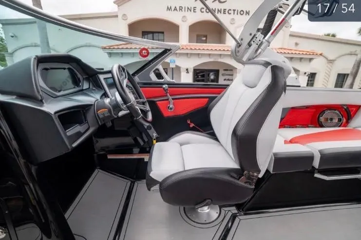Slide: The Image of 2019 MasterCraft XStar boat interior with modern dashboard and seating. - 14