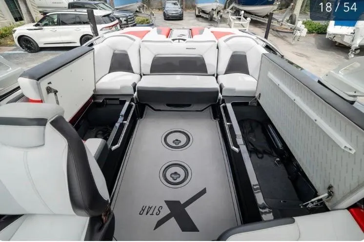 Slide: The Image of 2019 MasterCraft XStar boat interior with spacious seating and storage compartments. - 15