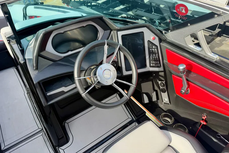 Slide: The Image of 2019 MasterCraft XStar boat cockpit with steering wheel and control panel. - 5